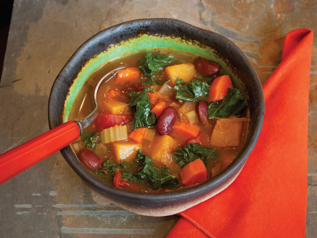 kale, bean and vegetable soup served in bowl