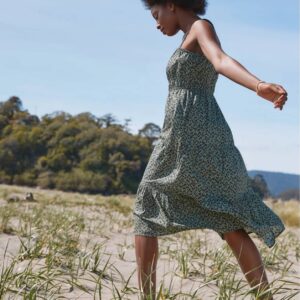 Woman wearing green, dotted dress on beach