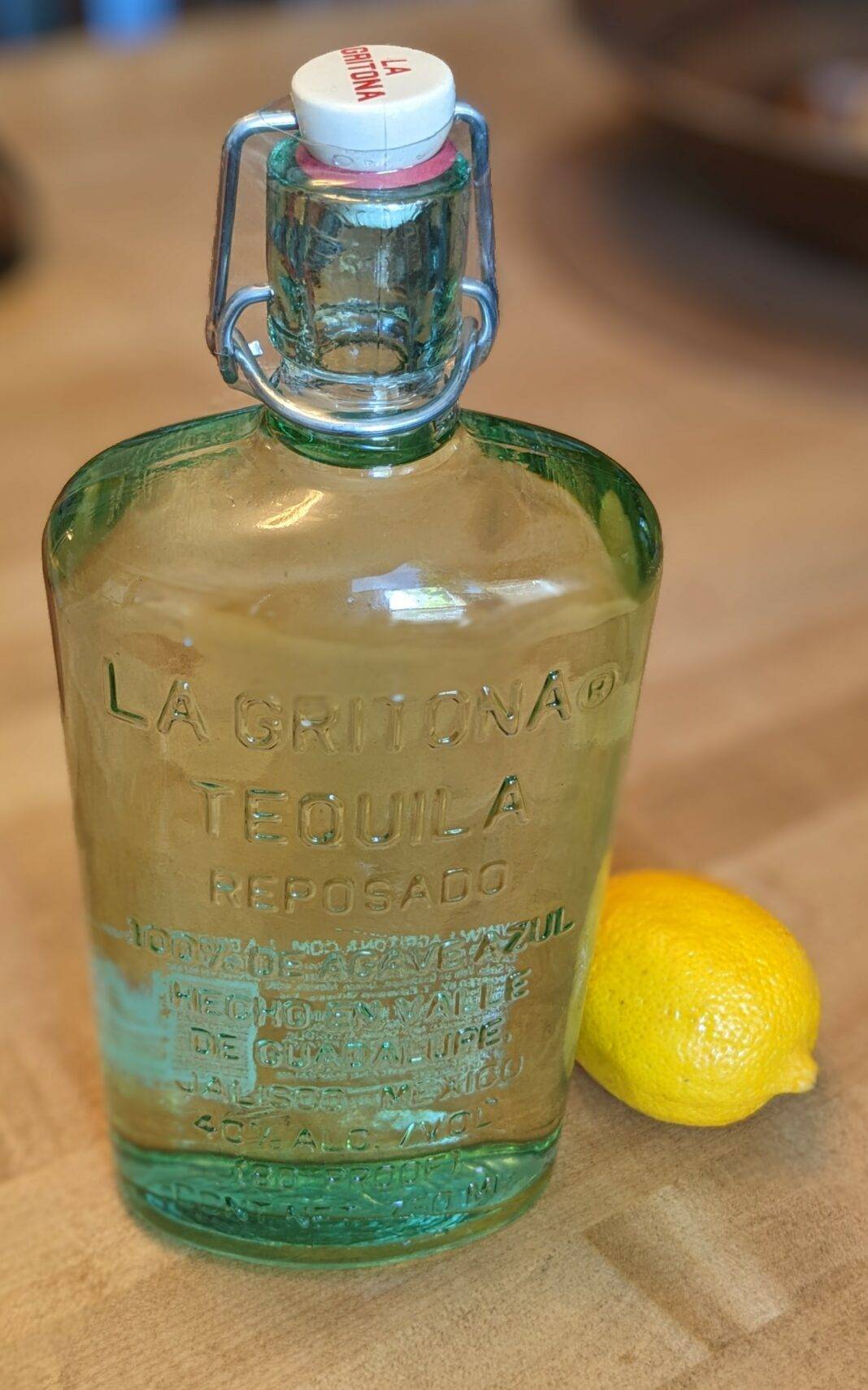 A bottle of La Gritona tequila with a lemon
