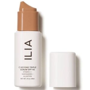 a white cosmetics container with a tan pump labeled with the brand name Ilia