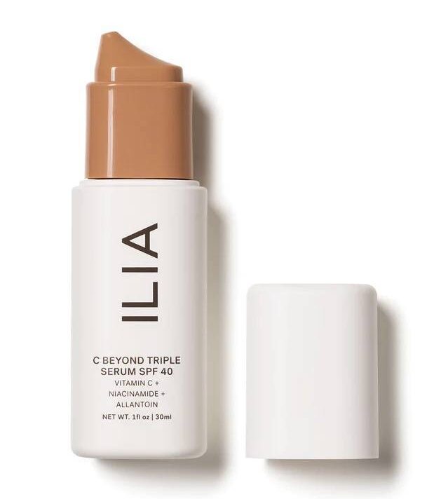 a white cosmetics container with a tan pump labeled with the brand name Ilia