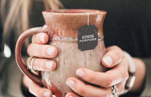 Hands holding a mug of Numi Tea