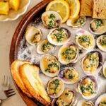Grilled littleneck clams in an herb, caper and butter sauce.