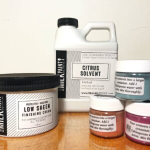A grouping of products from The Real Milk Paint Co., including paints, finishing creams, and stripper.