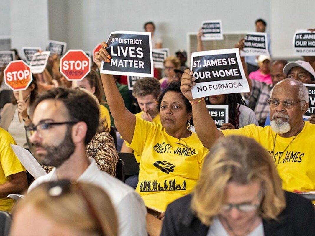 Sharon Lavigne (center) and RISE St. James members hold up signs during Louisiana’s Department of Environmental Quality’s public hearing on whether to approve air permits for Formosa Plastics on July 9, 2019.