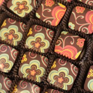 Stamped chocolates, painted green and red, made by Ragged Coast Chocolates. Photo by Doug Mindell.