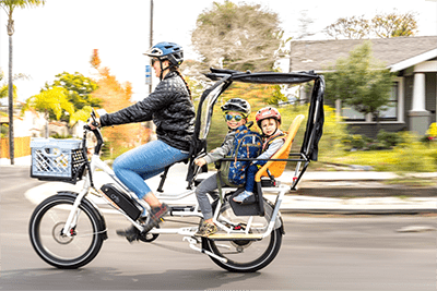 A family of four uses an e-bike around a San Diego neighborhood and for school commuting.