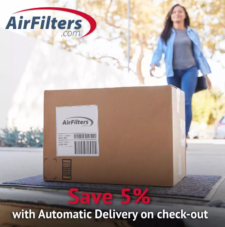A cardboard box with a delivery label from AirFilters.com sits in the foreground as a woman in blue jeans and a blouse comes to collect it.