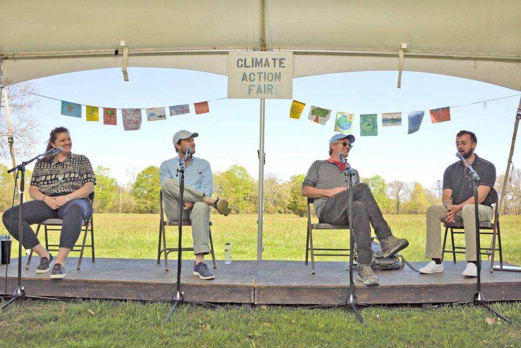 four people sitting under a tent as panelists