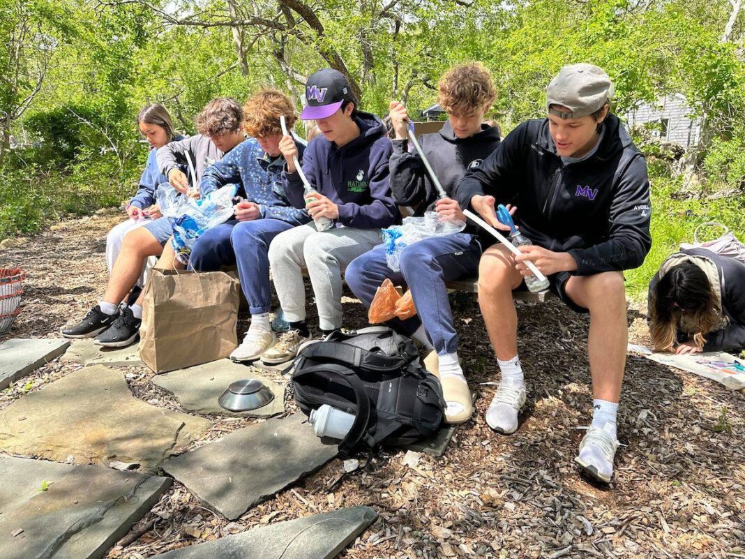A group of students make eco bricks as part of a workshop at Felix Neck led by Laurisa Rich.