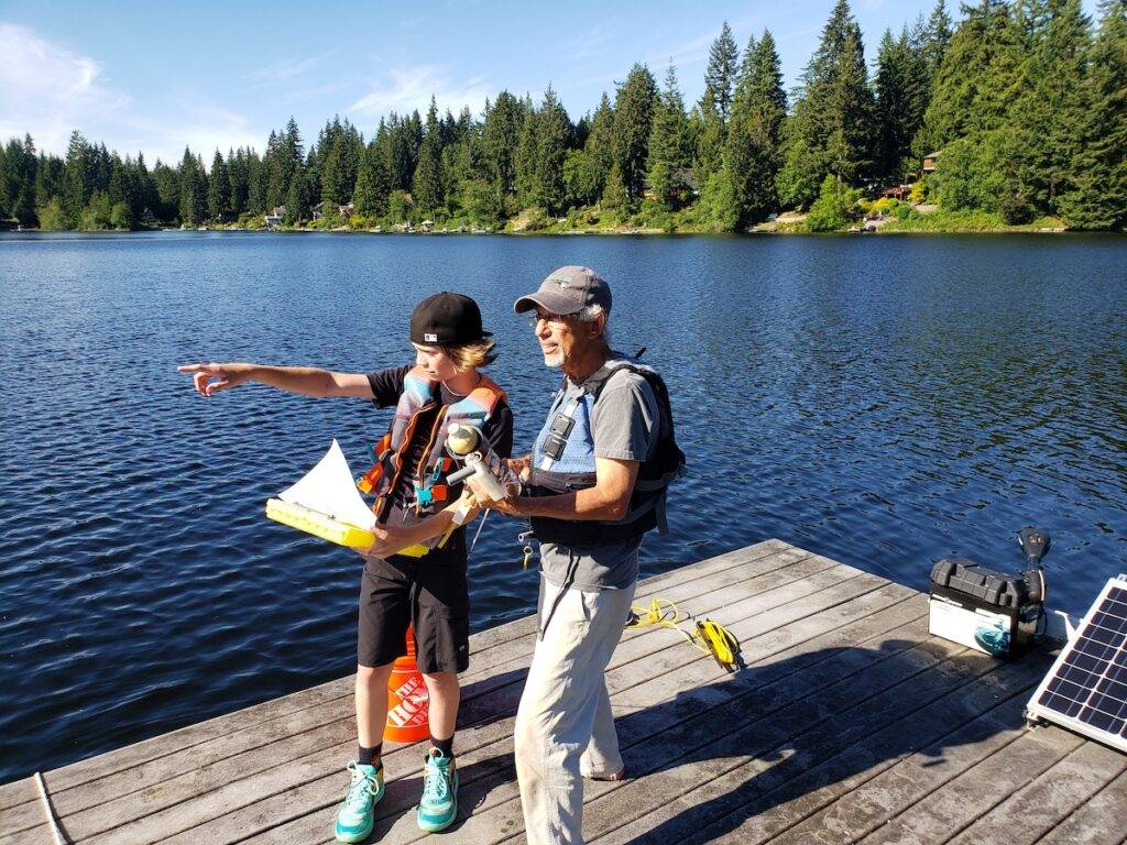 Ron Johnston-Rodriguez and grandson on a dock.