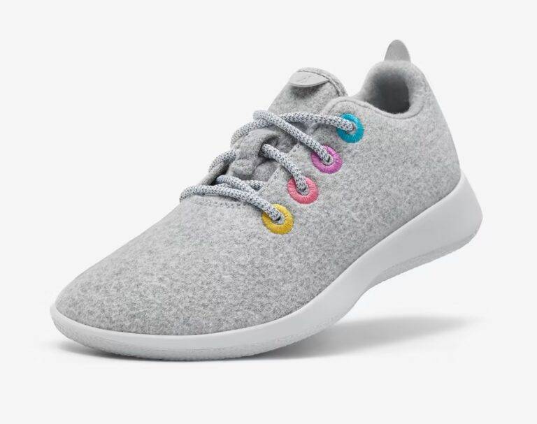 A gray wool tennis shoe with yellow, orange, pink, and teal eyelets for the laces. 