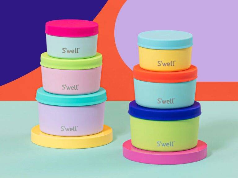 Two stacks of three colorful food containers with the brand label S'well.