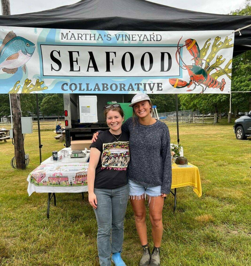 Phoebe Walsh, left, and Adelaide Keene work at the Seafood Collaborative market