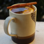 Hot cider with orange slice and cinnamon stick.