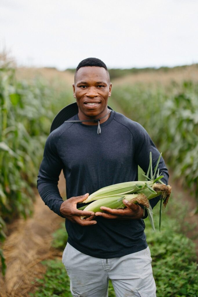 Seneth Waterman holding a husk of corn