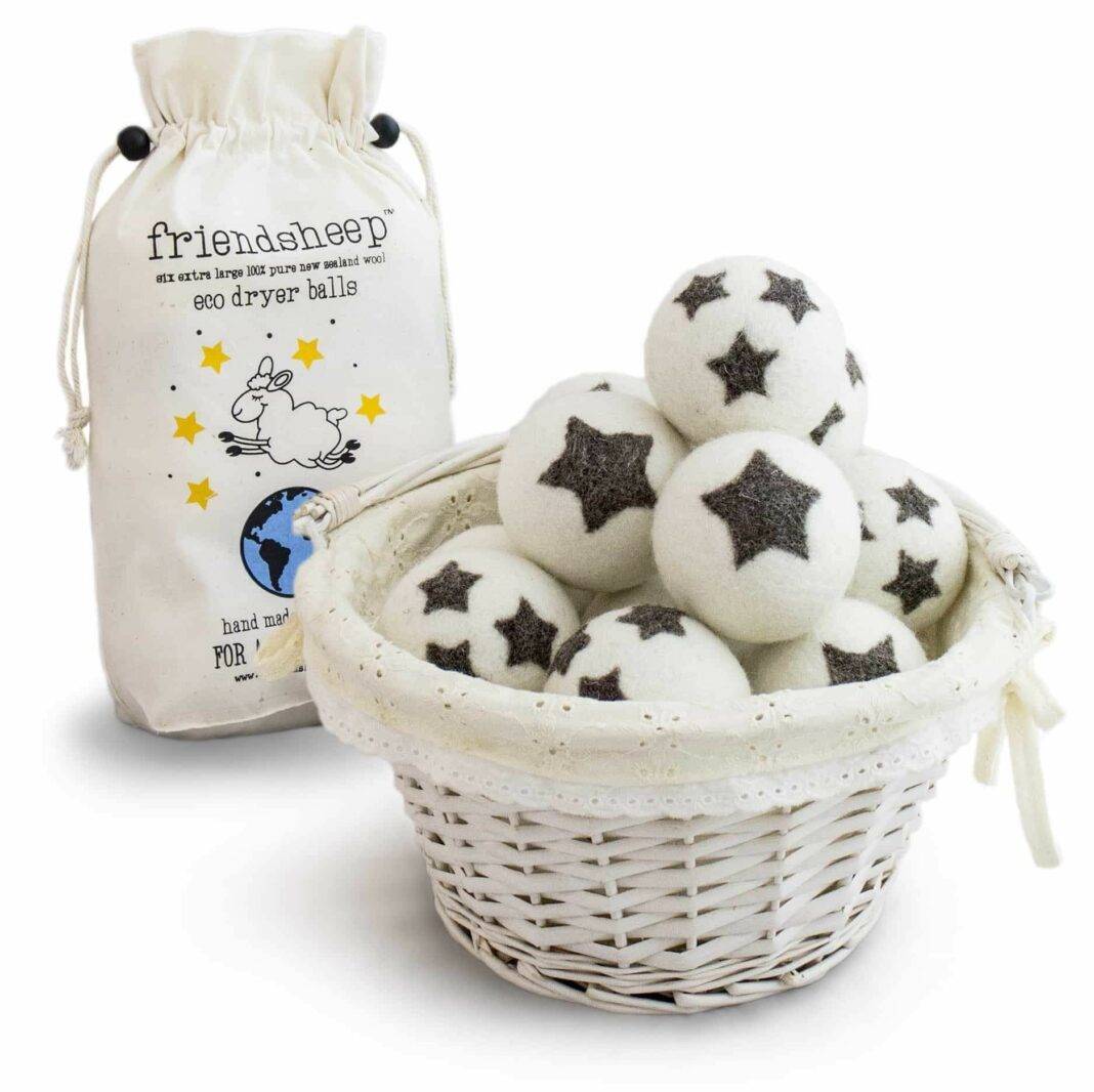 A basket containing wool balls with stars on them and a bag behind it saying it with the brand name Friendsheep.