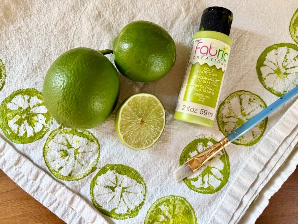 limes painted on a white tea towel