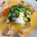 bay scallops with a ginger-orange sauce and asian greens plated