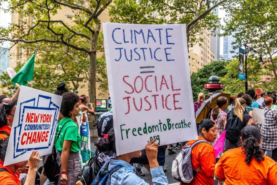 activists marching holding climate justice signs