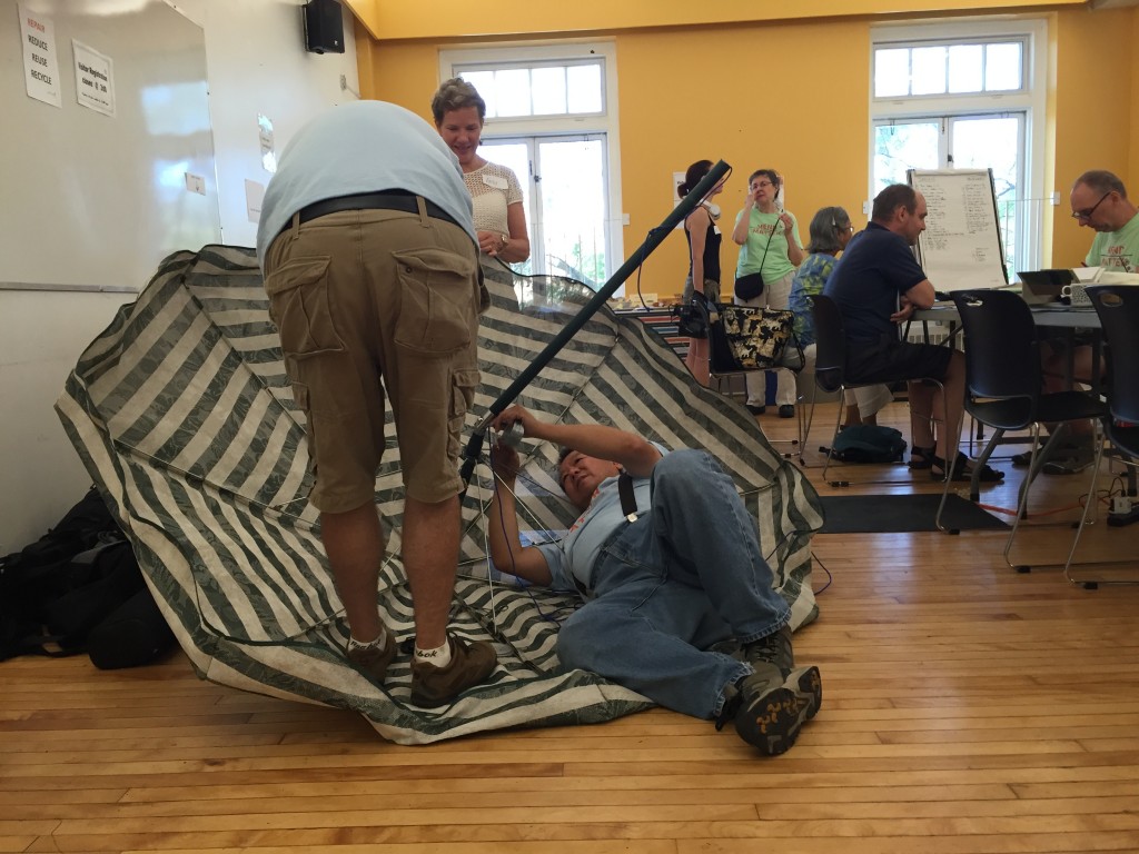 Two volunteers repairing an umbrella