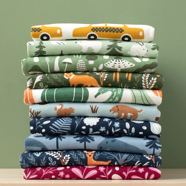 A stack of shirts in cheerful colors. 