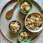 large bowl with smaller bowls of roasted cauliflower and cheese