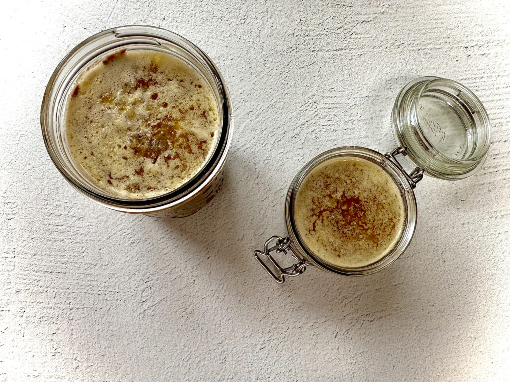 Prepared pate in jars topped with melted butter.