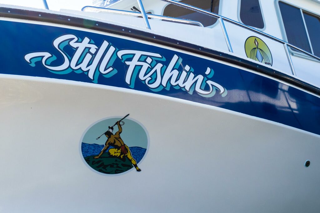 front of boat with Still Fishin' name 