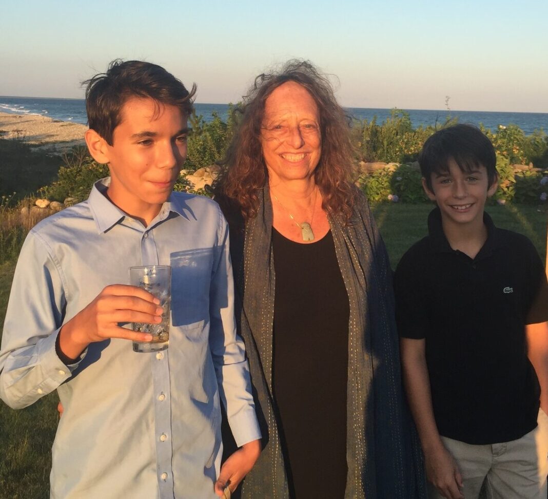 women and boys near shoreline