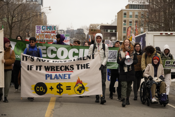 Amalie Wilkinson leads a group of protestors at the University of Toronto.