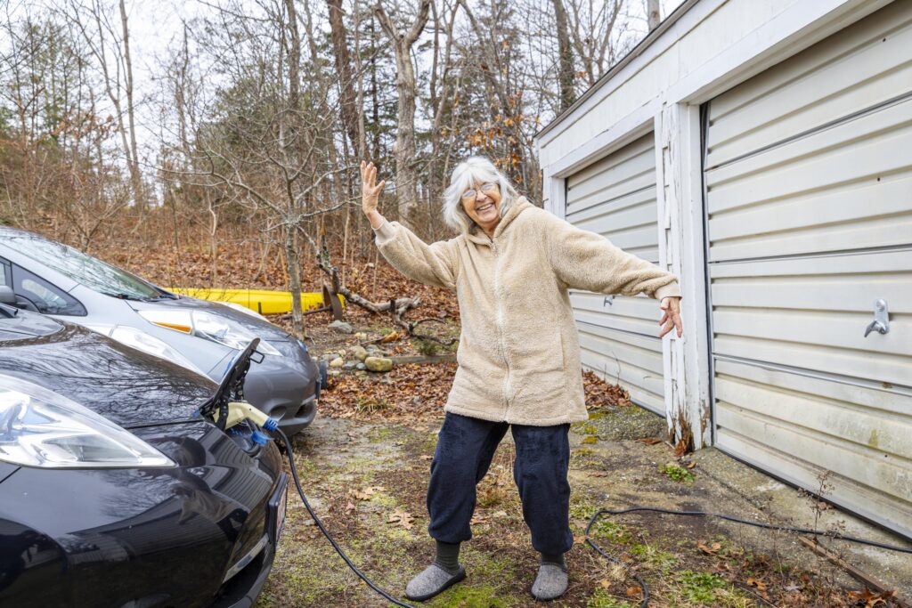 person with electric car charging