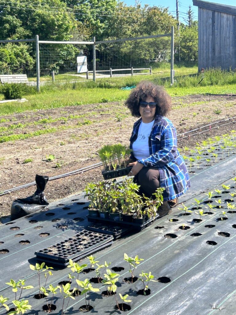 A woman holding plants.