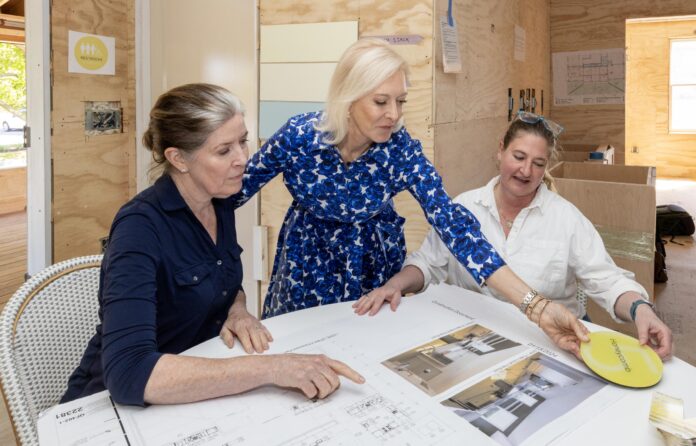 Anne Dougherty, Wendy Schmidt and Jenn King review building plans at The Hive.