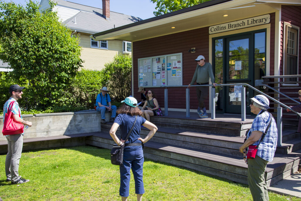 several people gathered on lawn of library