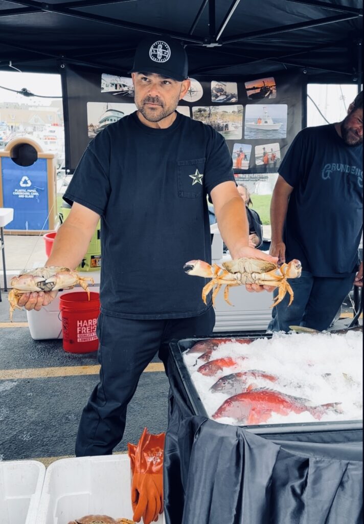 man with crab in hand at fish market