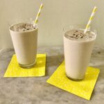 two smoothies in glasses on yellow napkins