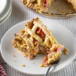 Rhubarb pie with lattice top served on a plate.