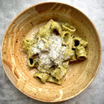 rigatoni pasta with pesto in a bowl