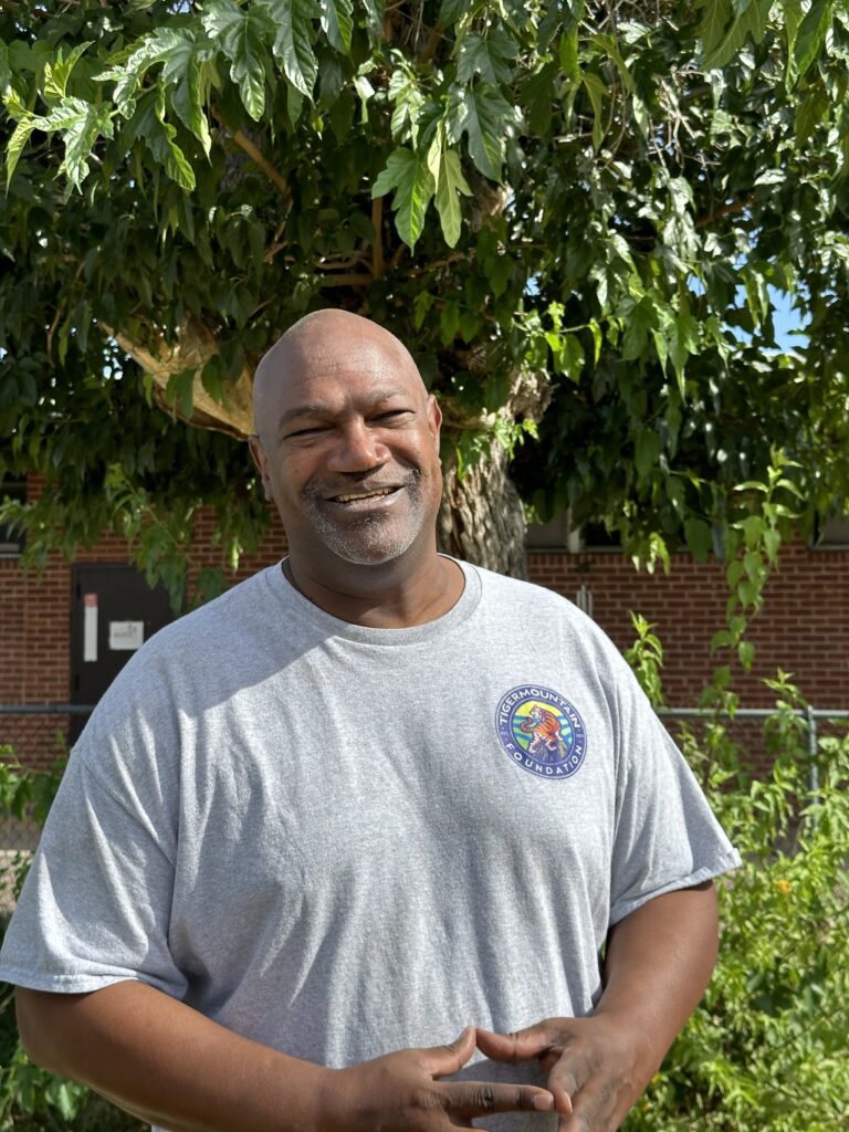 A man stands in a garden.