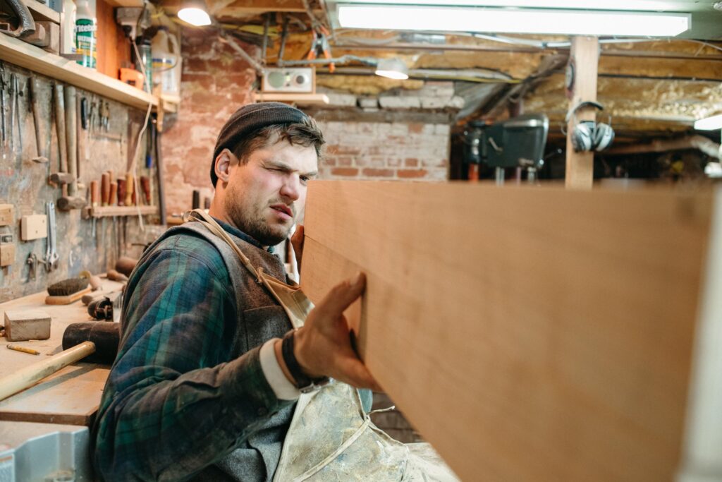 a man holding a plank of wood