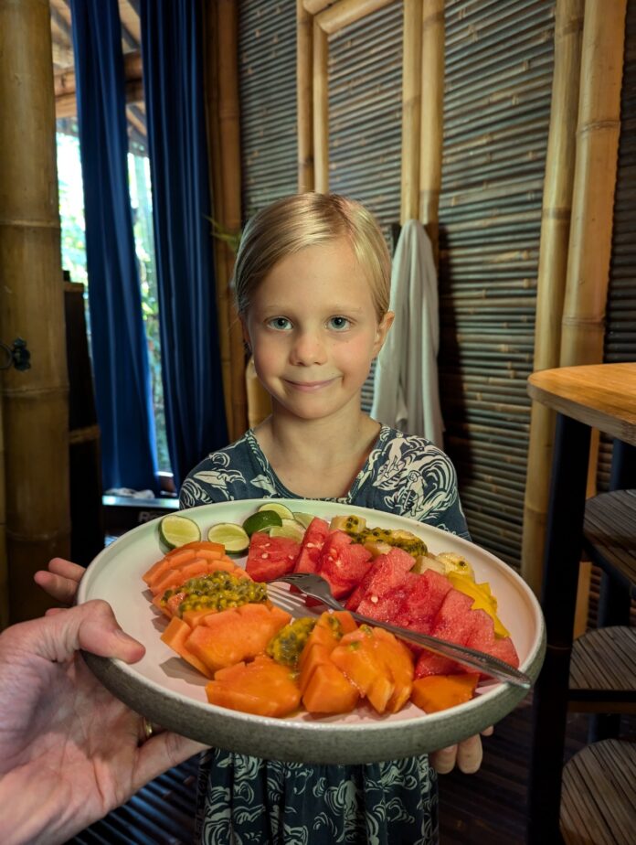 Navy Fallows, ready to chow down. a child is served a plate of fruits and vegetables