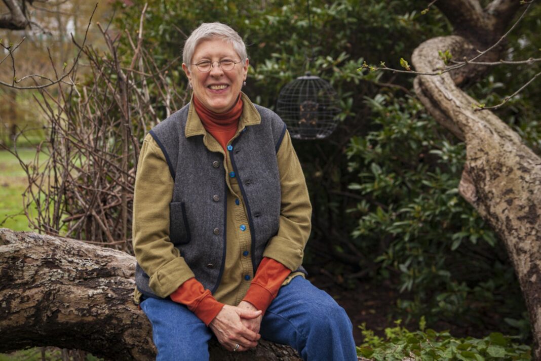 a woman sitting outside and smiling