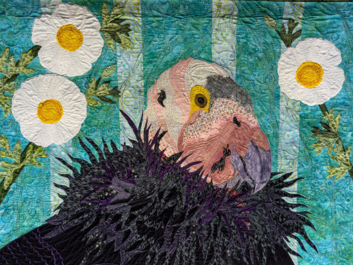 a quilt with the design of a condor in it