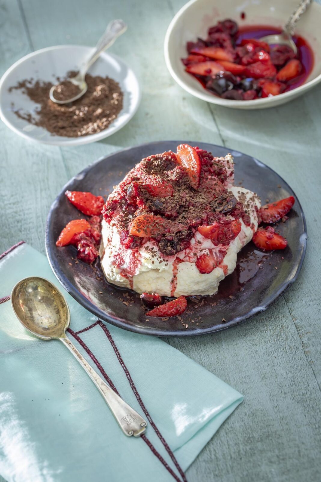 a cake topped with red sauce and strawberries