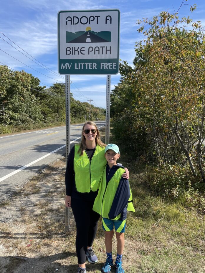 a woman and her son stand alongside a bike path