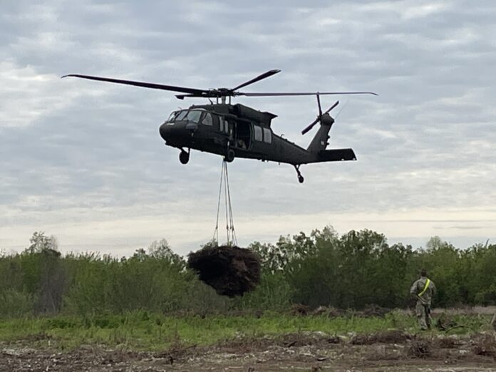 a helicopter transporting a christmas tree