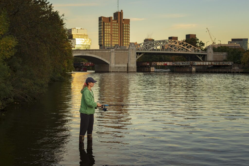 a woman casting her rod to fish