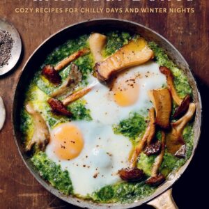 A cookbook cover showing a pan full of greens, eggs, and mushrooms, and the words “Warm Your Bones: Cozy Recipes for Chilly Days and Winter Nights” by Vanessa Seder.