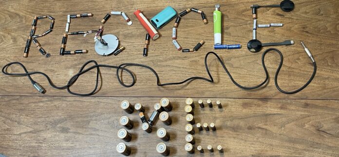 batteries arranged in a way that spells out "recycle me"